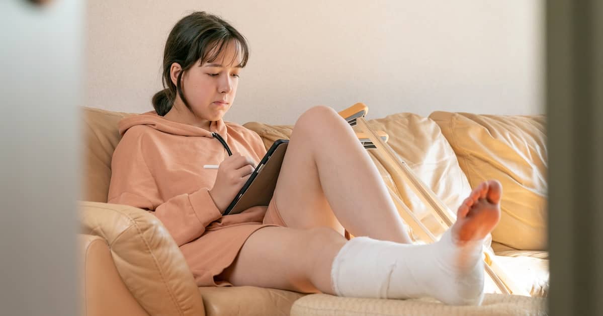 girl in leg cast sits on couch | Boller and Vaughan